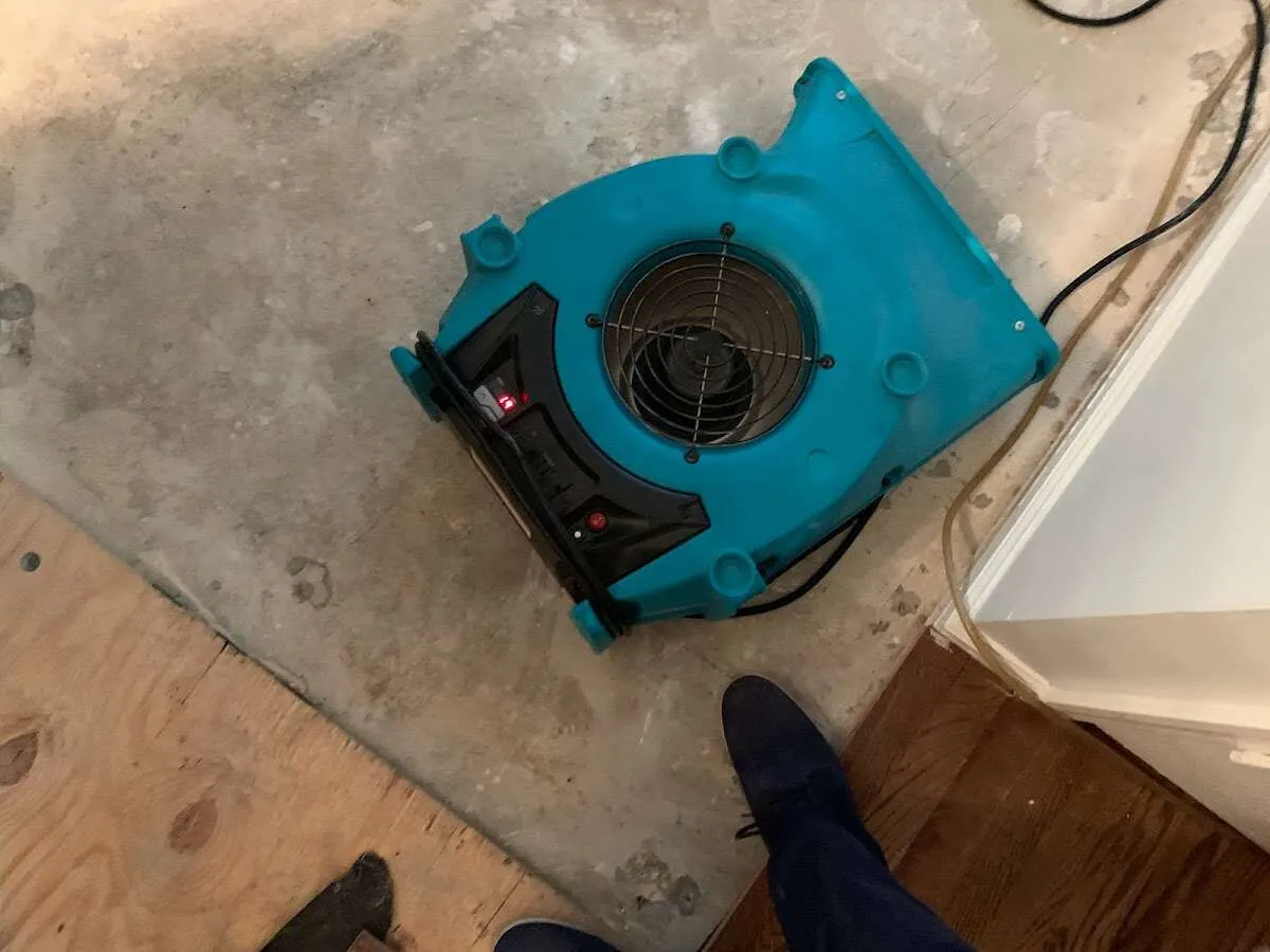 Air mover drying subfloor during Commercial Water Damage Restoration in Quakertown